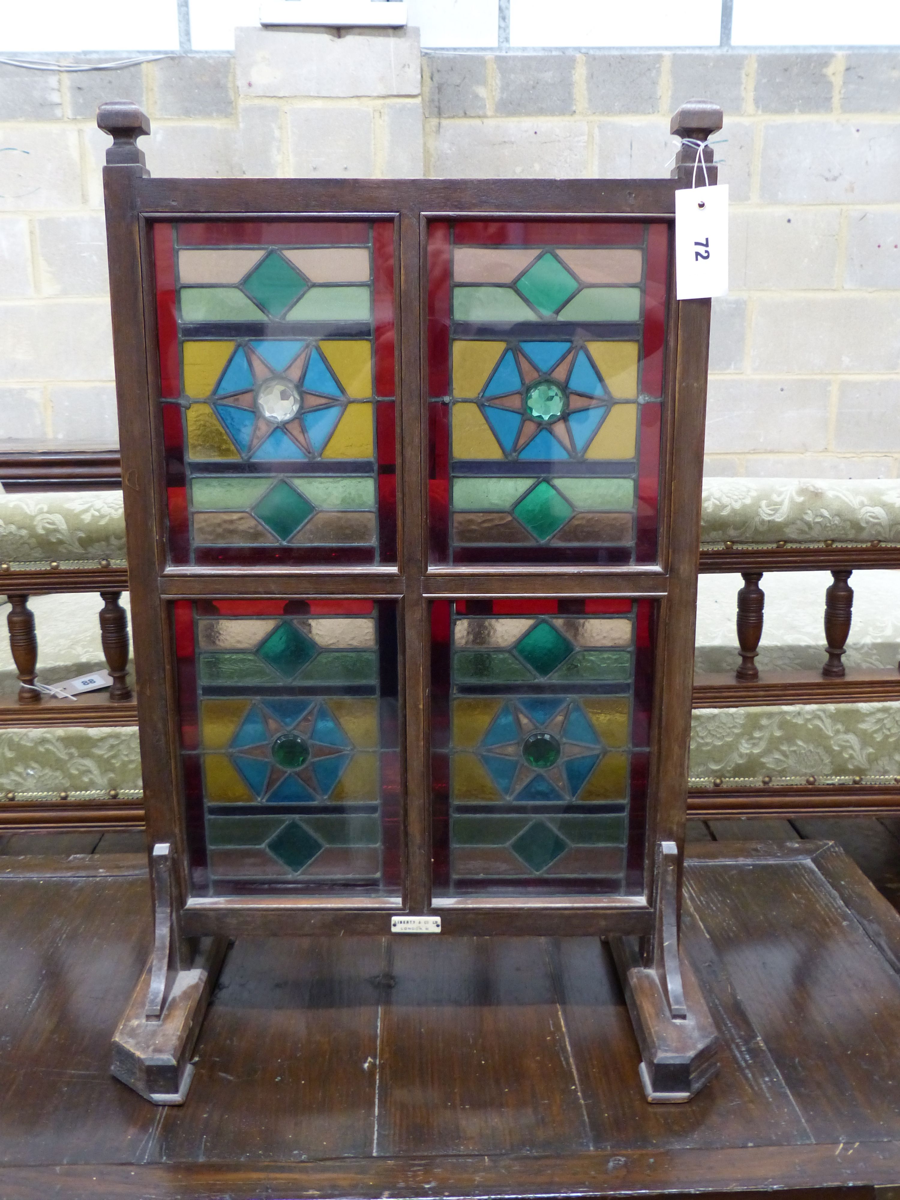 An Edwardian Liberty & Co. stained glass and beech leaded glass room screen, width 43cm, height 67cm